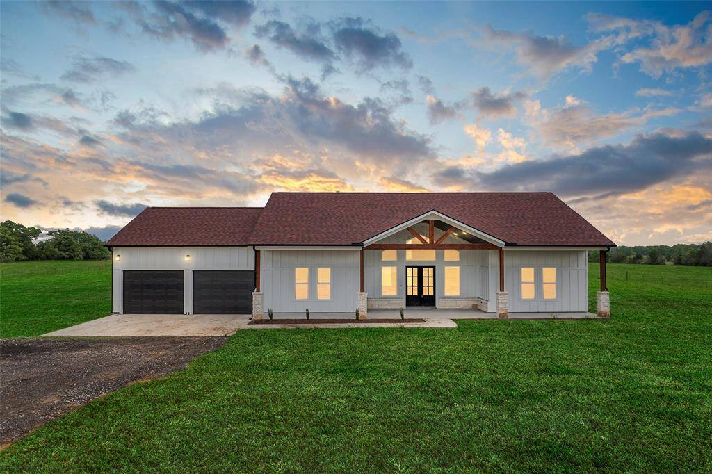 There are 3 Bedrooms with Owner's Retreat in the back of the home with an Ensuite Bath. You will enjoy entertaining family and friends on your Texas sized Covered Patio. EXTRA DEEP GARAGE for big trucks and ATV's measuring 24X31. Don't miss the half bath out there! The acreage is a blank slate, make your dreams come true here! Madisonville CISD.