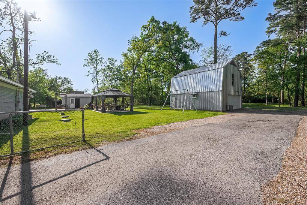 Convenient paved driveway leads to a spacious two-story workshop.