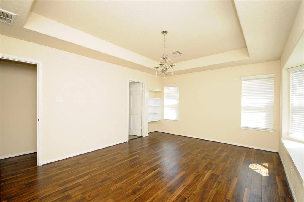 Primary suite with tray ceiling and chandelier