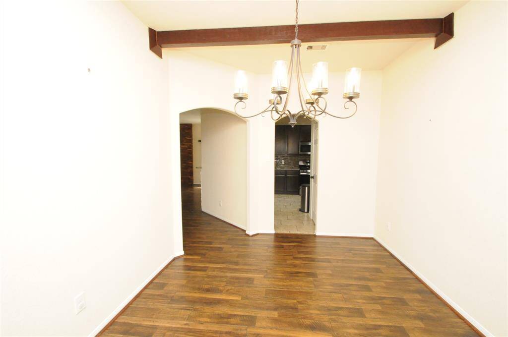 Formal dining room with wood beams