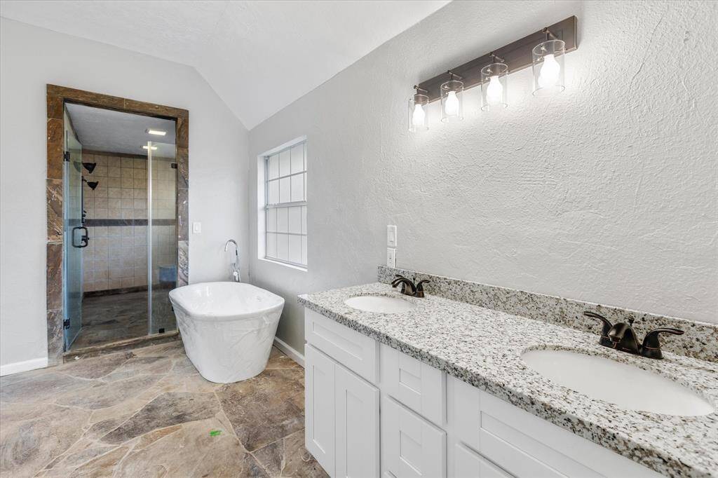 First floor Primary Suite Bathroom. Featuring a shower, a bathtub, and two hand sinks.