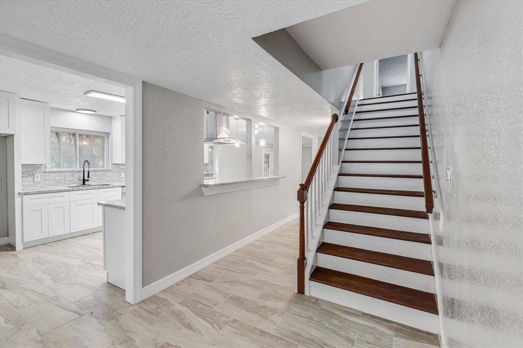 Where the Kitchen meets the beautiful staircase to the Second floor.