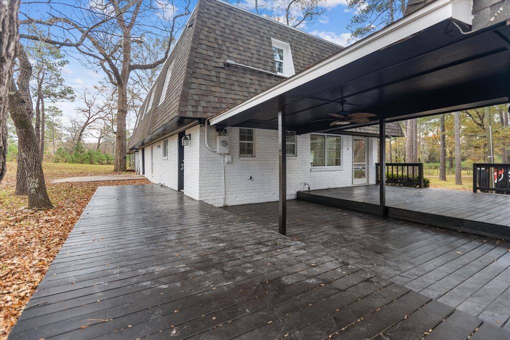 Beautiful wood dock adjoining the enclosed front porch and the Kitchen, with the Garage and Garage Apartment.