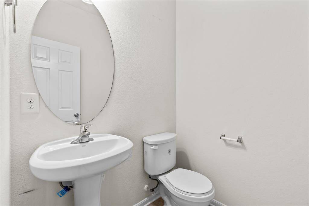This room features neutral walls, clean carpeting, and a large window offering ample natural light. Ideal for a bedroom or home office.