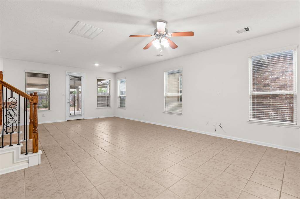 Bright kitchen with ample natural light, featuring wooden cabinets, spacious countertops, ideal for cooking and entertaining.