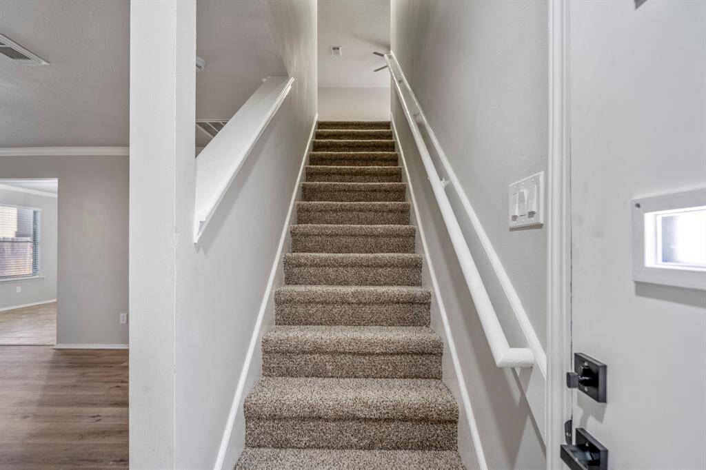 Newly installed carpet offers a soft transition as you head upstairs to the second level.