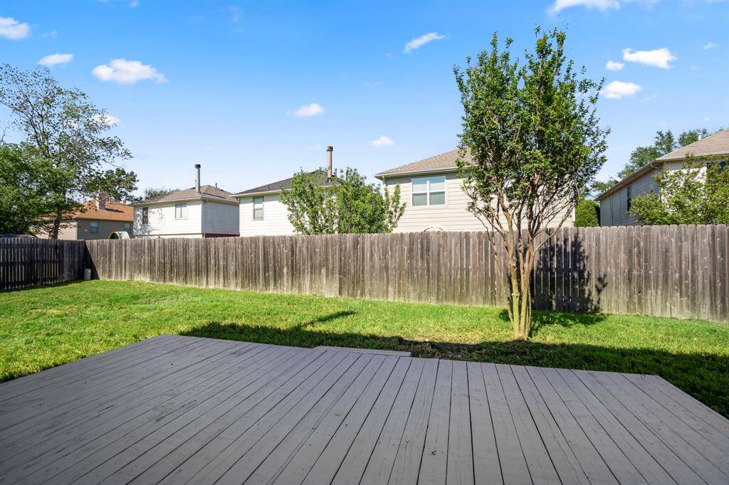 Step out back and enjoy a spacious yard with room to roam and a wood deck that's perfect for grilling, relaxing, or hosting friends and family.