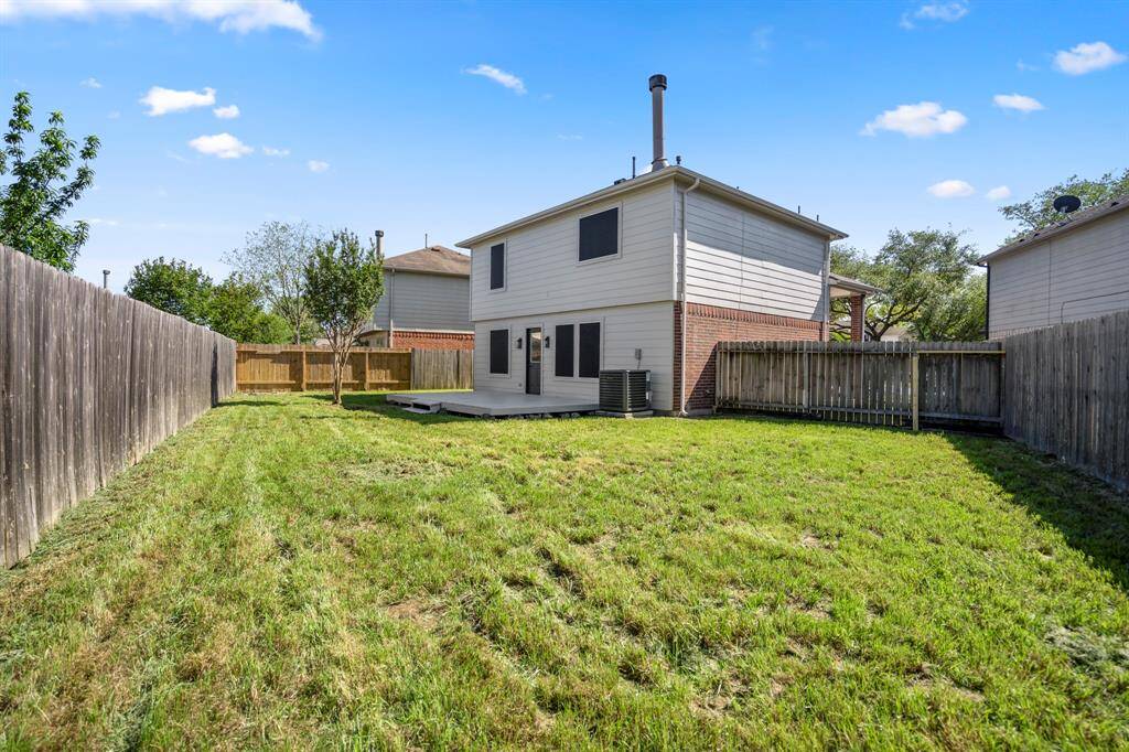 Step out back and enjoy a spacious yard with room to roam and a wood deck that's perfect for grilling, relaxing, or hosting friends and family.