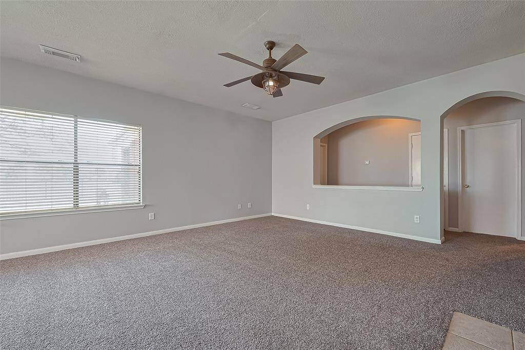 As you walk through the home, you'll see the family room and hallway that leads to the bedrooms.  Lare window overlooking the backyard and lake views.