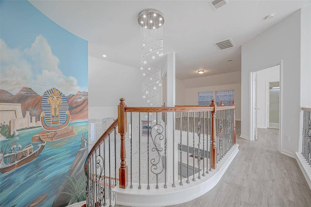 Upstairs view of the beautiful wall mural and dazzling chandelier.