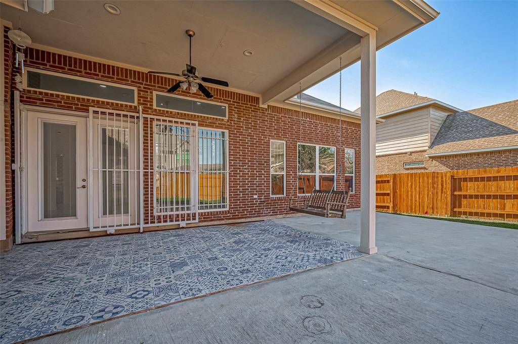 Outdoor Features: Extended Covered patio with tile pavers and a hanging swing. Backyard has guava, orange and fig trees.