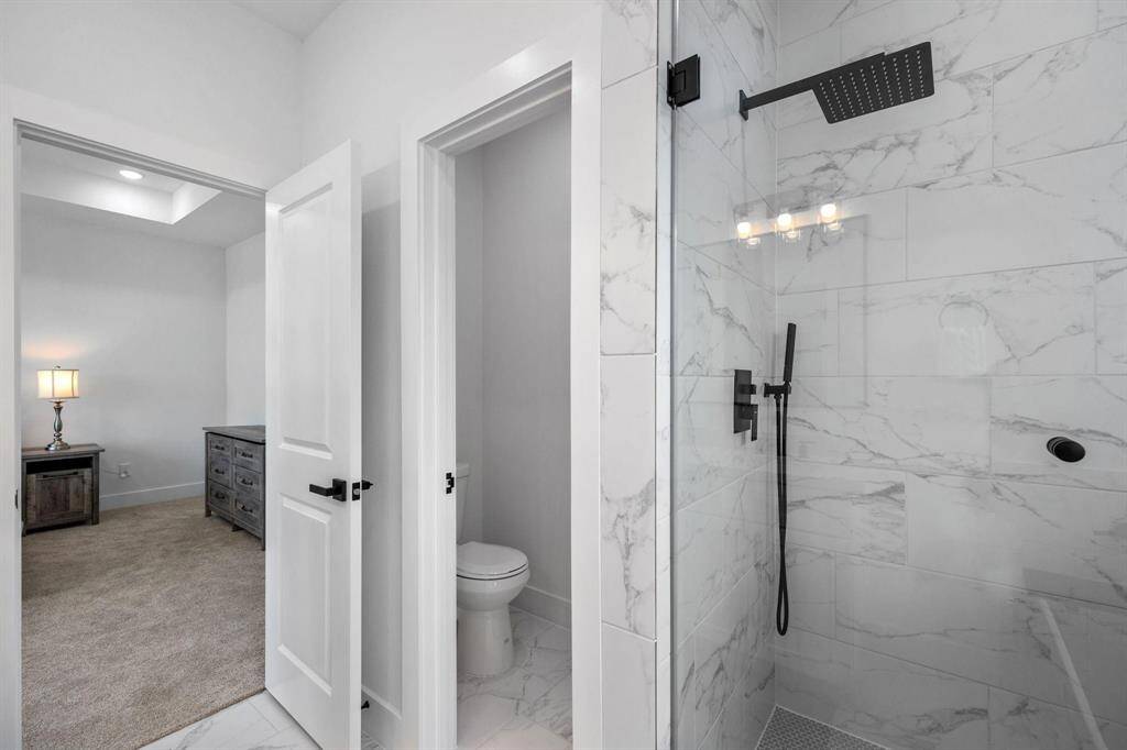 Primary bathroom oasis with double vanity, separate soaking tub, and shower