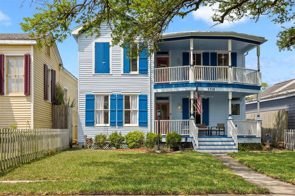 Charming two-story home with a classic facade and vibrant blue shutters. Features a welcoming porch on both levels, a well-maintained lawn, and a cozy fenced backyard. Ideal for enjoying outdoor living in a quaint neighborhood.