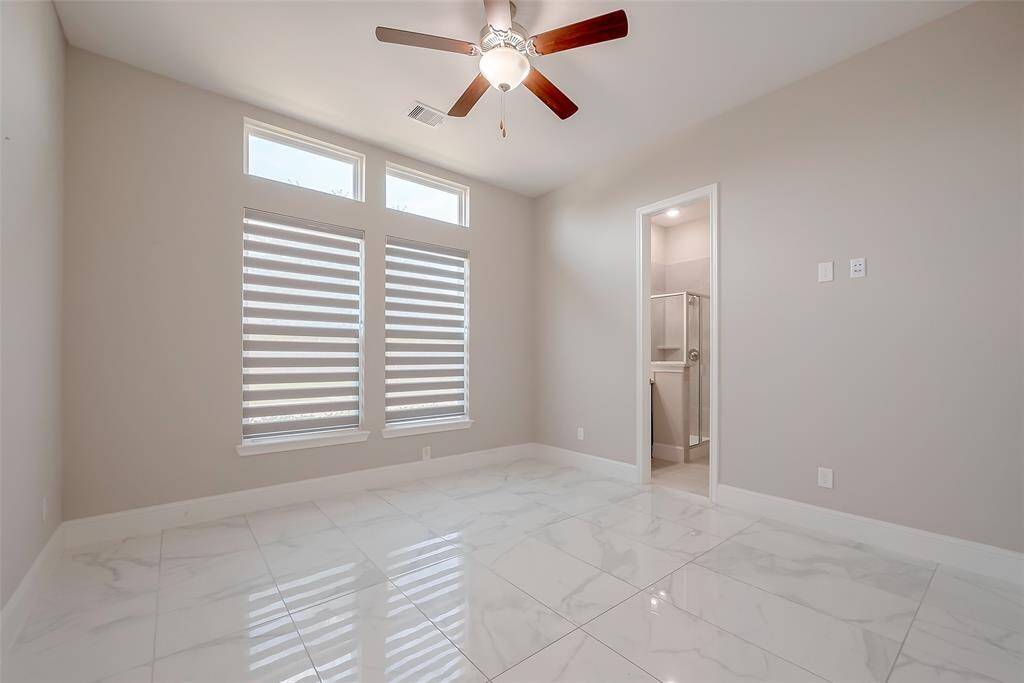 An inviting guest suite is located downstairs near the entry, offering privacy and comfort for visitors.