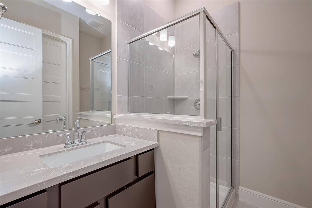 Guest ensuite bathroom features a standing shower for added convenience.