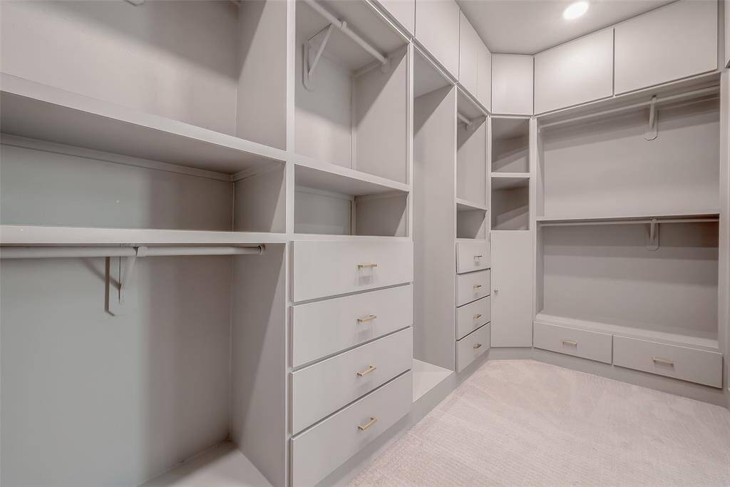 The huge walk-in closet features custom cabinetry, perfect for organizing your wardrobe and displaying your most prized possessions!