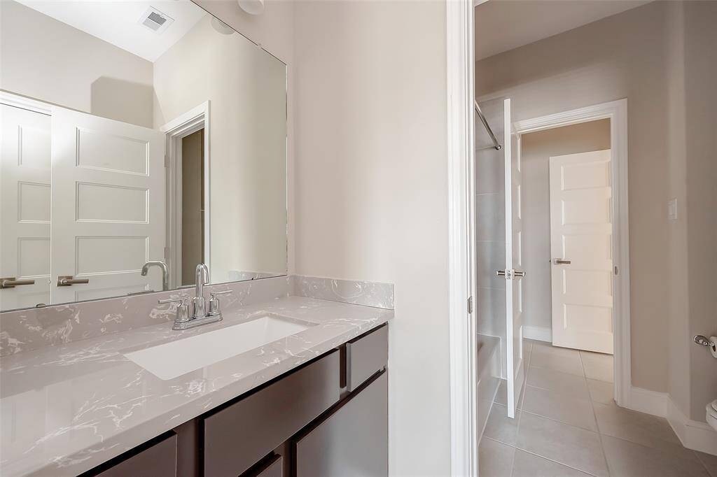 A full bath upstairs with separate vanity areas for added convenience.