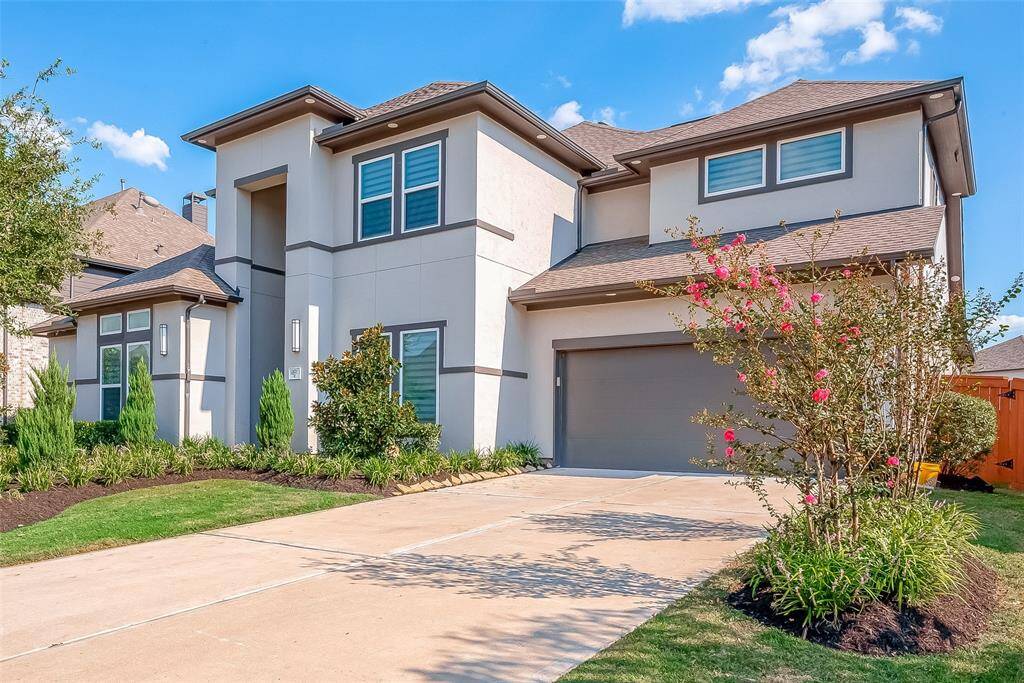 3-car tandem garage with built-in cabinets and EV charger included! Full rain gutters around the home.