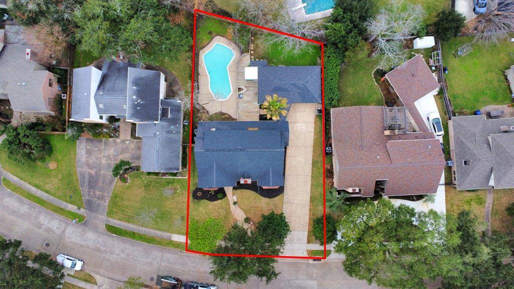 Vast 11,000 SF lot featuring a long double-wide driveway, offering ample parking, along with a 2 car garage.