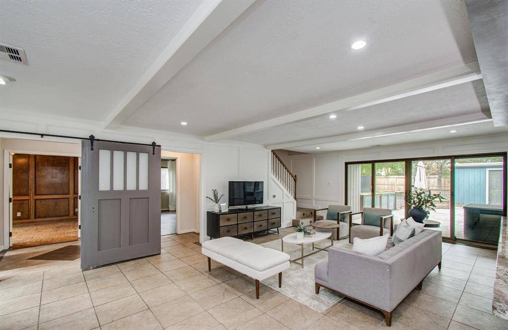 A view of the backyard thru a wall of windows -- natural light fills the room from all angles!