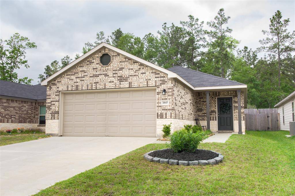 Welcome home to this beautiful brick and stone front exterior, featuring a charming front patio.