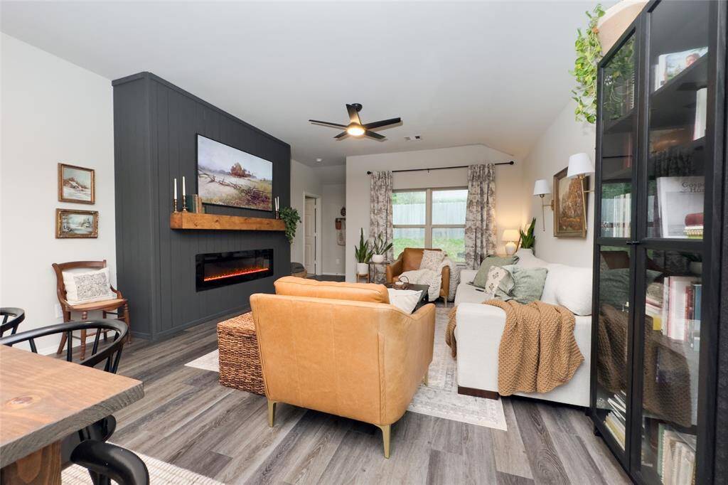 The kitchen area flows right into the dining and living room, making it great for entertaining guests. The living area features a built-in mock fireplace with a light wood mantel and a new ceiling fan-perfect for staying cozy all year round.