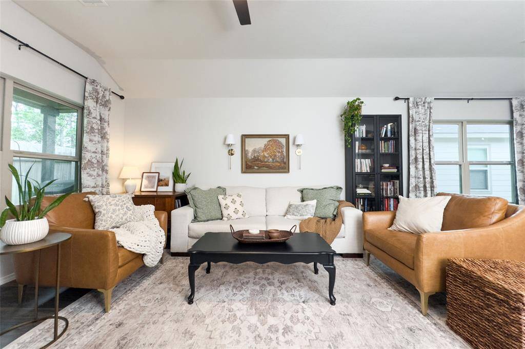 The kitchen area flows right into the dining and living room, making it great for entertaining guests. The living area features a built-in mock fireplace with a light wood mantel and a new ceiling fan-perfect for staying cozy all year round.