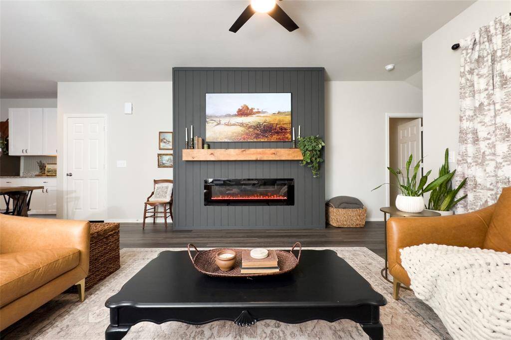The kitchen area flows right into the dining and living room, making it great for entertaining guests. The living area features a built-in mock fireplace with a light wood mantel and a new ceiling fan-perfect for staying cozy all year round.
