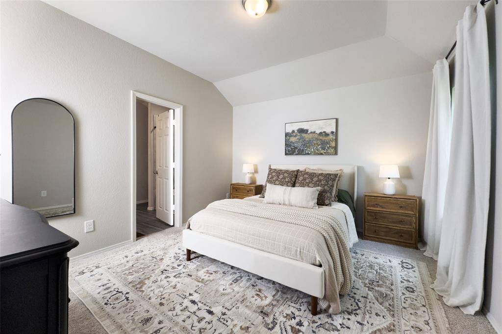 The primary bedroom is tucked away at the back of the home, giving you a peaceful view of the mature trees located at the back of the home.