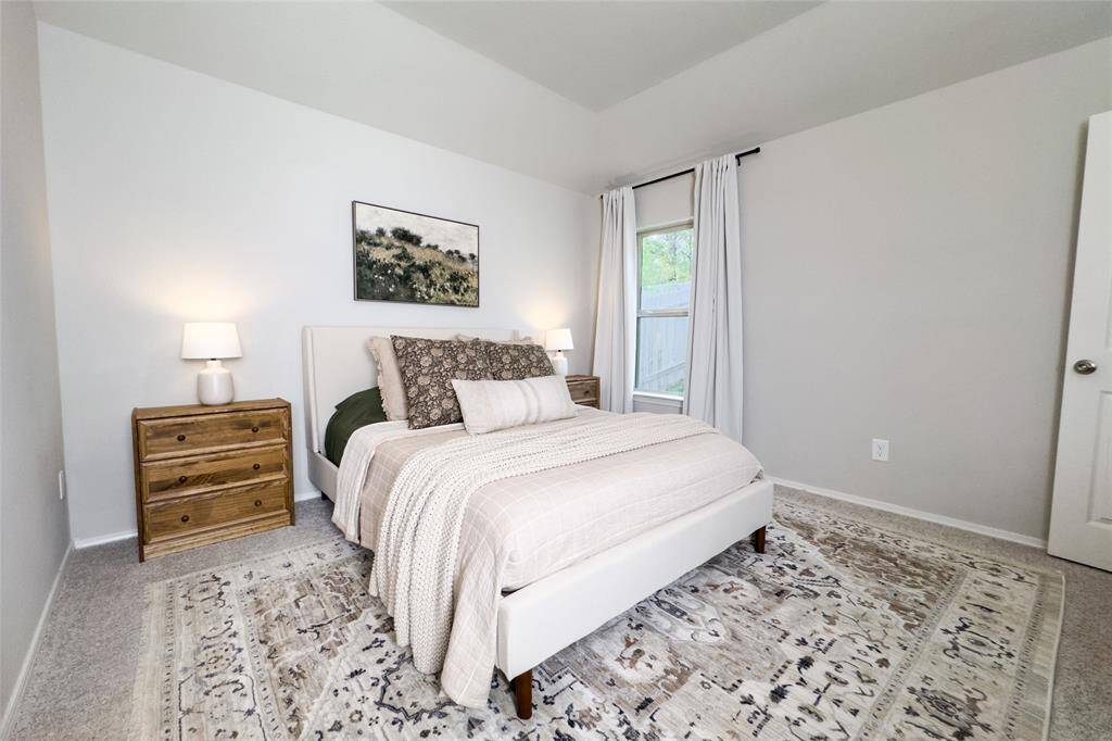 The primary bedroom is tucked away at the back of the home, giving you a peaceful view of the mature trees located at the back of the home.