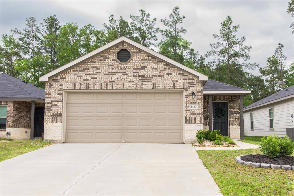 Welcome home to this beautiful brick and stone front exterior, featuring a charming front patio.