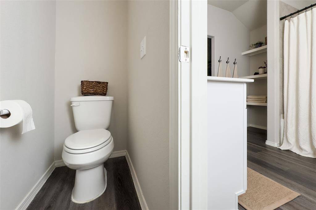 The primary bathroom offers plenty of space, updated shower head, good size closet, and built-in shelves that are perfect for storage.