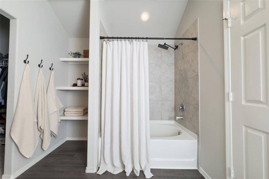 Your primary bathroom offers plenty of space, updated shower head, good size closet, and built-in shelves that are perfect for storage.