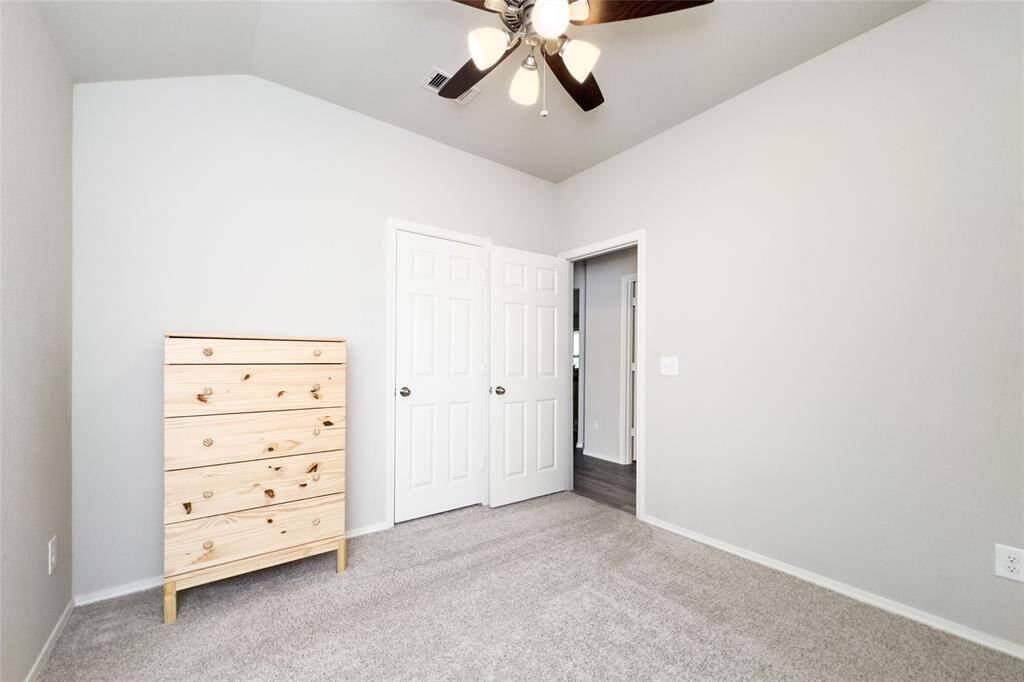 Cozy spare bedroom with a brand new ceiling fan.