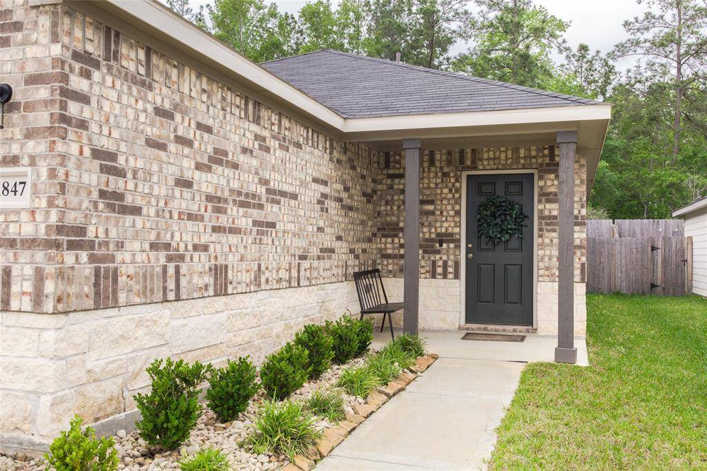 Welcome home to this beautiful brick and stone front exterior, featuring a charming front patio.