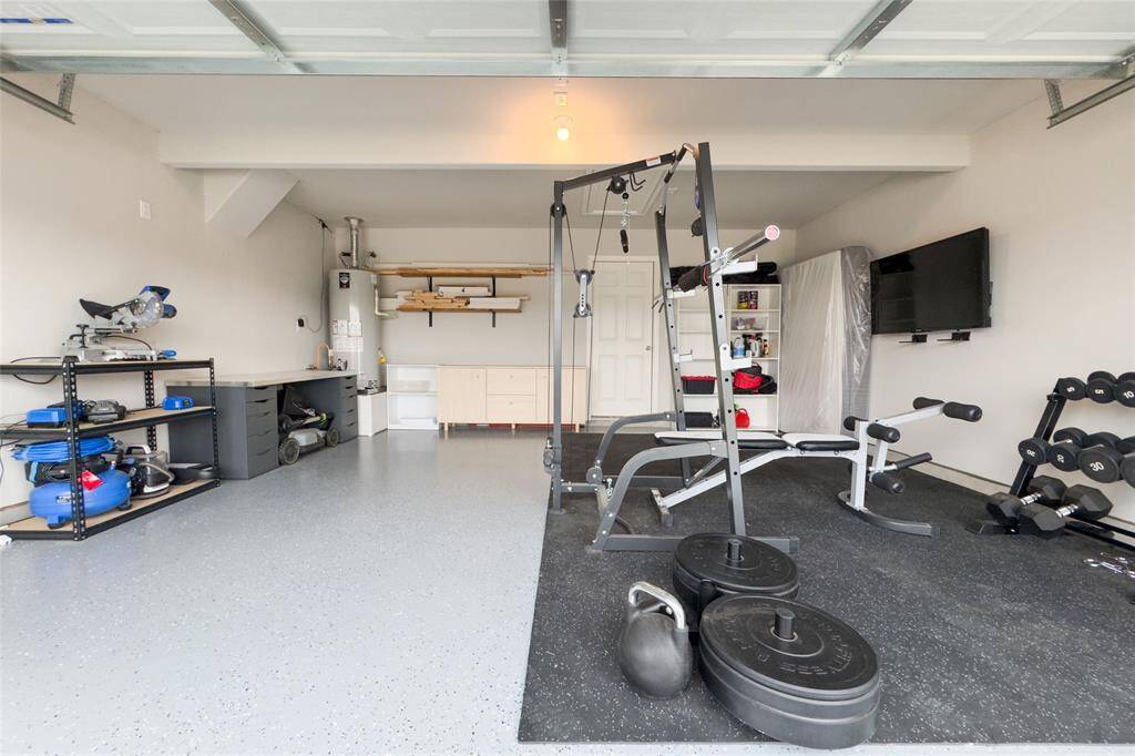 The two car garage features newly finished epoxy flooring and built in shelves.