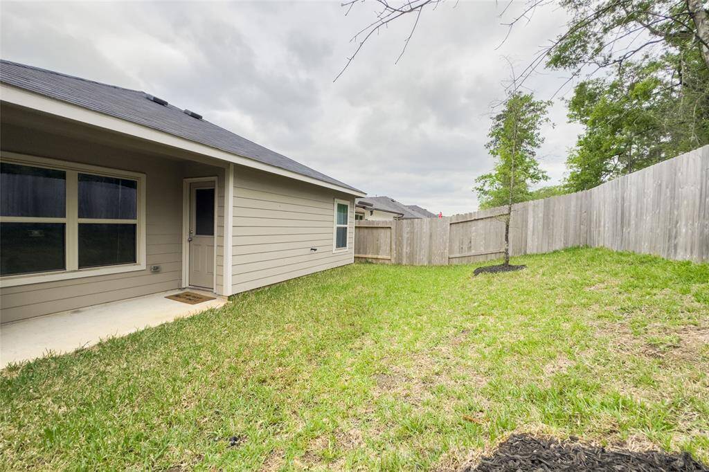 The home features a covered patio overlooking a beautiful scenery and mature trees.
