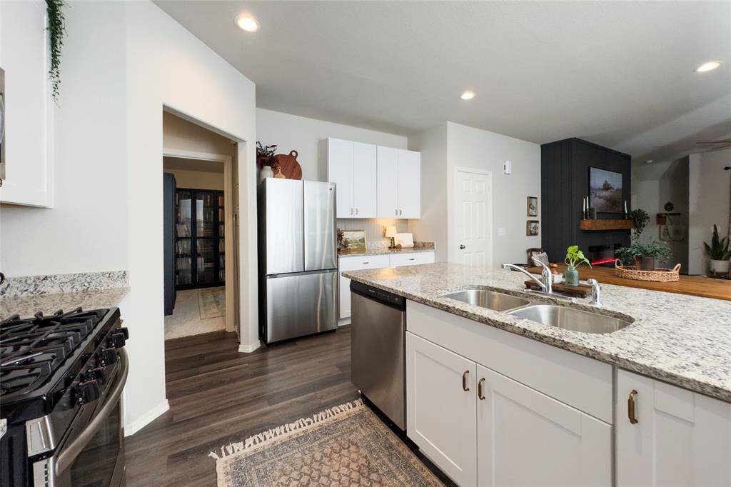 Check out this gorgeous kitchen featuring 42' white kitchen cabinets, updated gold hardware, updated backsplash, granite countertops, and freshly painted island that pulls everything together perfectly.