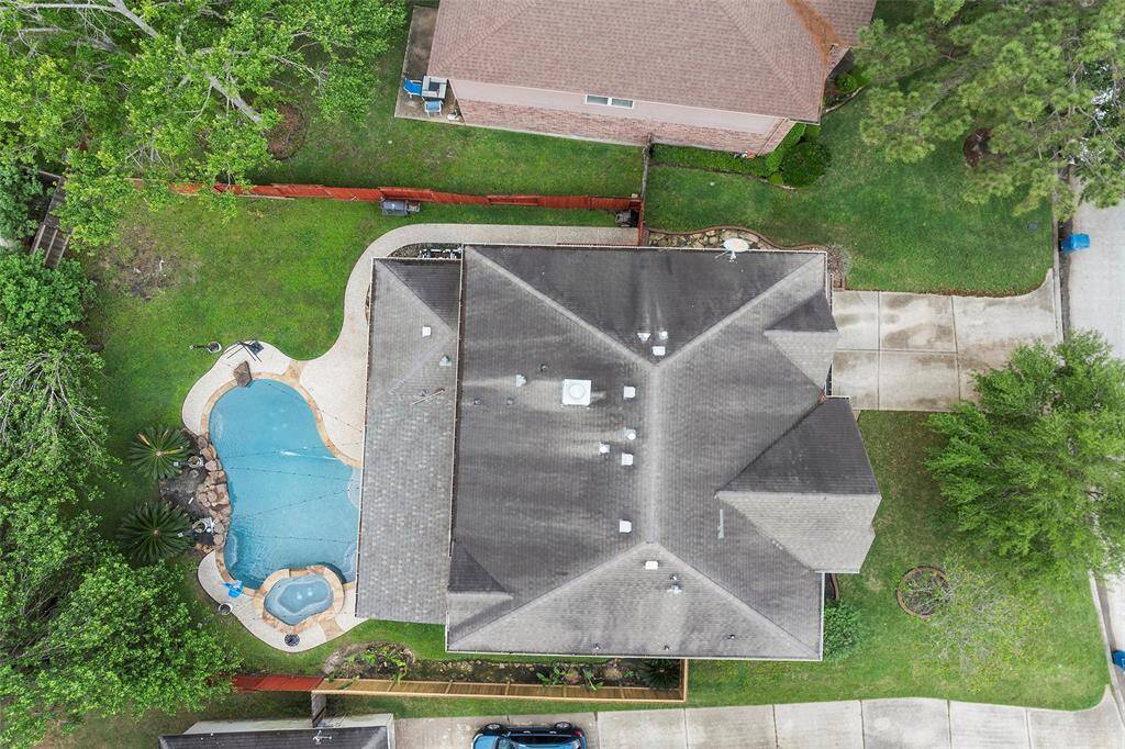 An aerial view of your private oasis. Spacious subdivision lot with a fully fenced backyard and heated pool.