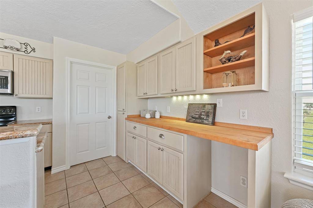 Additional cabinetry and a built-in serving station offer the perfect space for entertaining.
