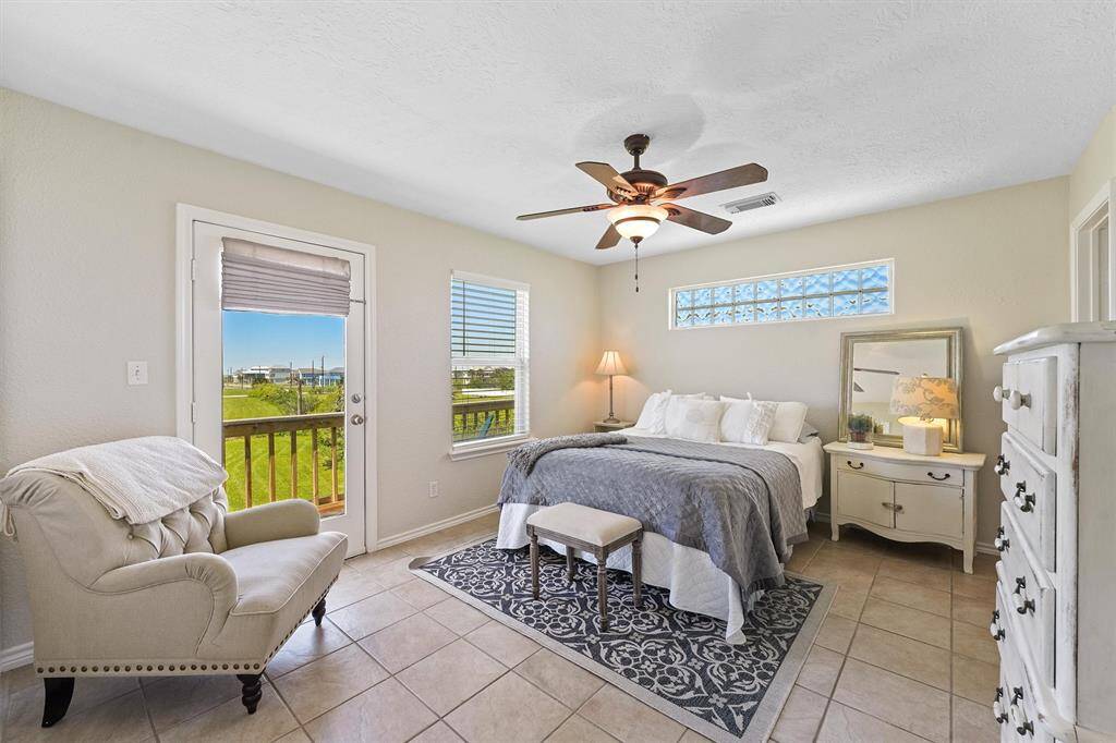 Spacious primary suite with private balcony access and relaxing bay views.