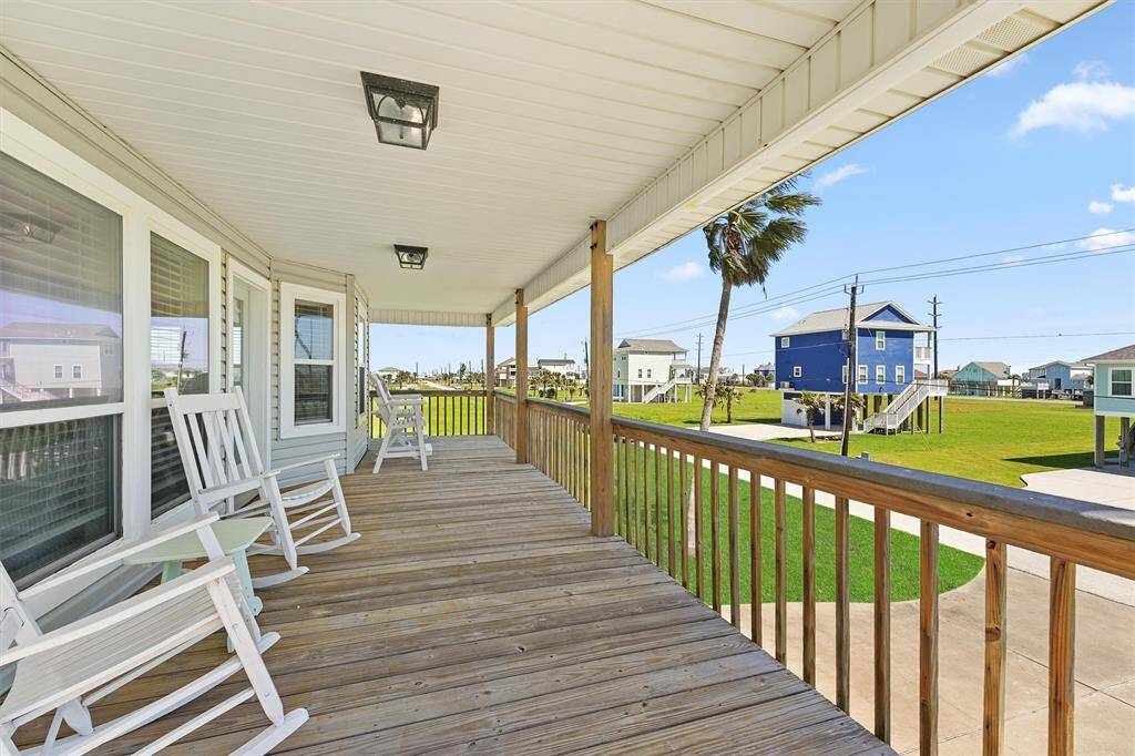 Spacious front deck with rocking chairs offers a perfect spot to enjoy the ocean breeze.