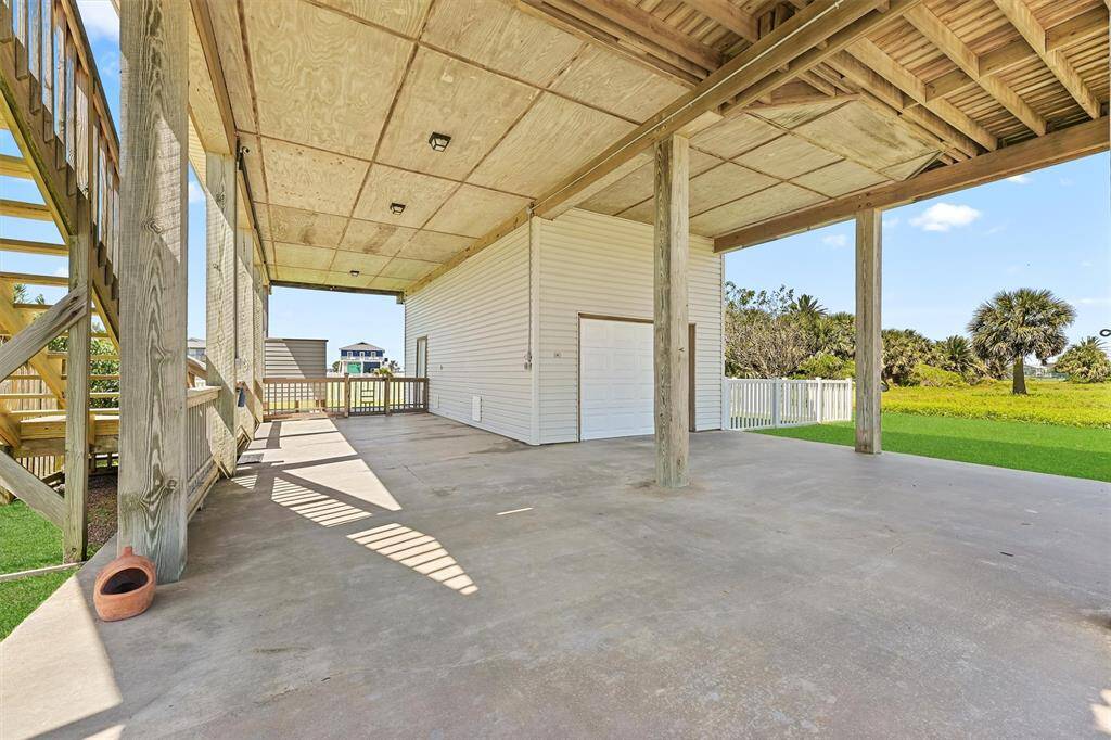 Additional ground-level view showing open space for entertaining and access to the fenced backyard.