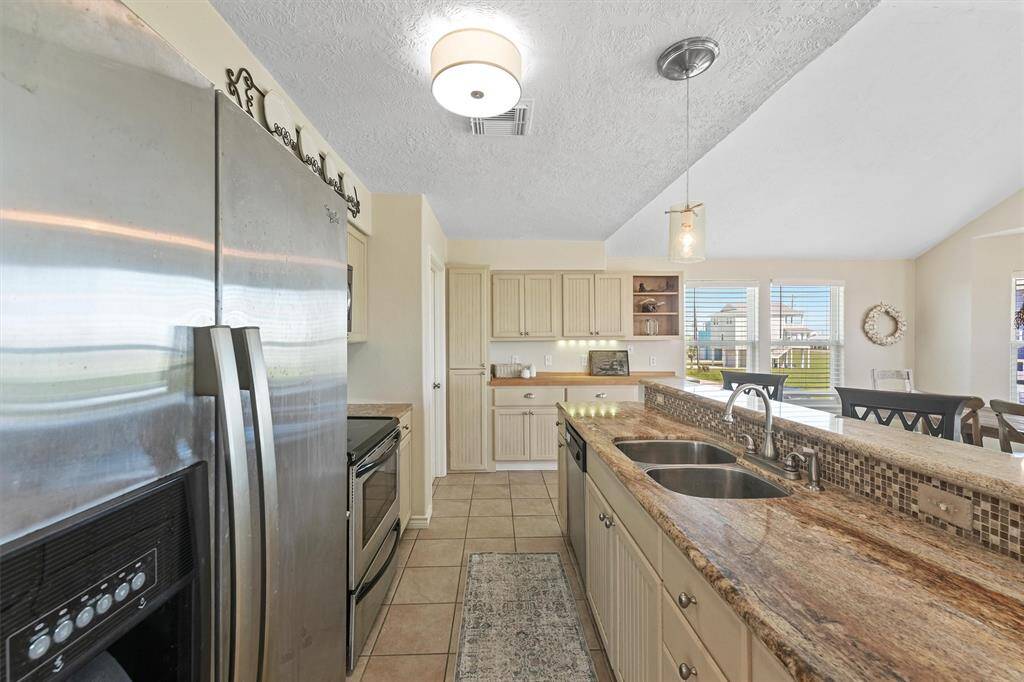 Bright and airy kitchen with a window-lined wall providing plenty of natural light.