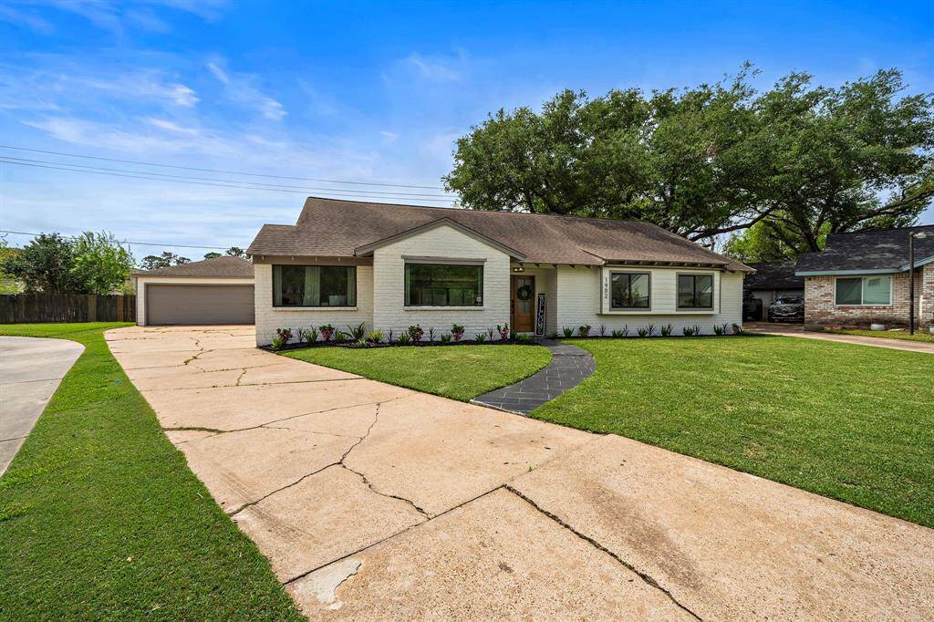 View of the curve appeal of the home with its oversized driveway