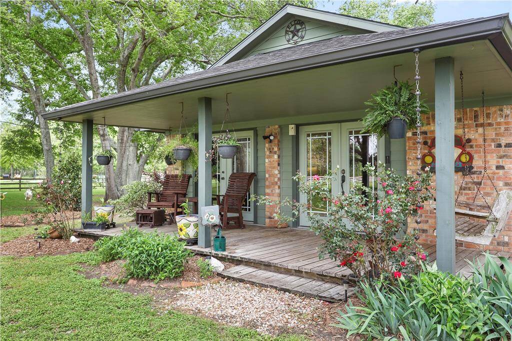Surrounded by lush greenery, this porch is ideal for serene relaxation.