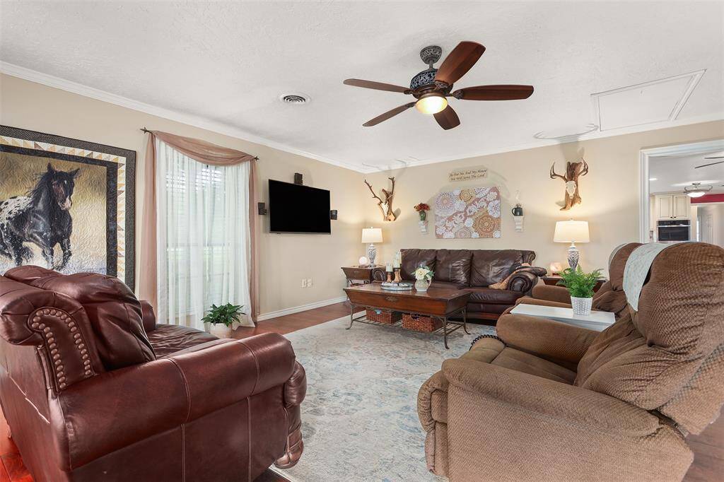 Spacious family room bathed in natural light through two sets of doors.