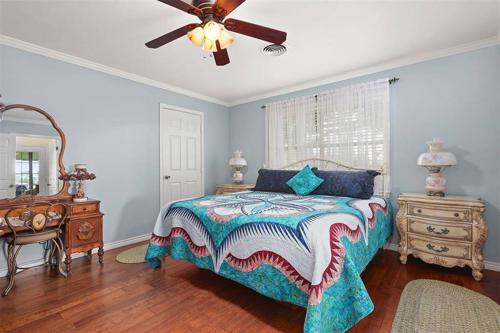 Large second bedroom with elegant decor and ample natural light.