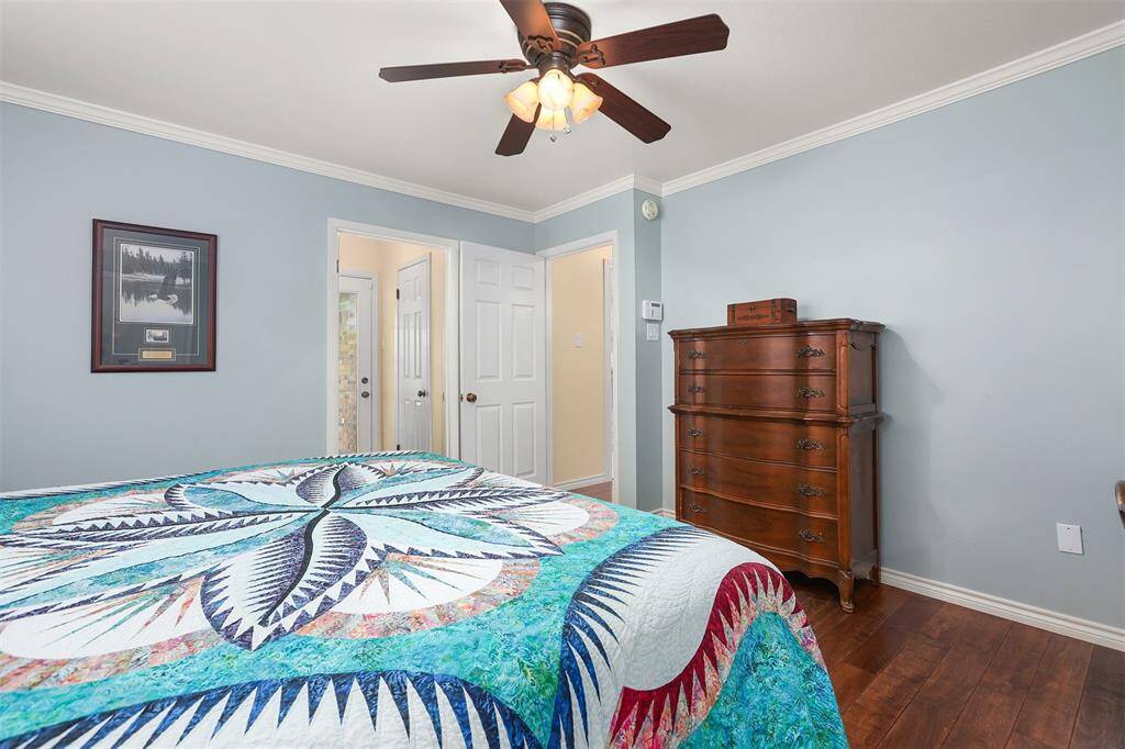 Quietly tucked away at the back of the home, this serene bedroom offers privacy and comfort.