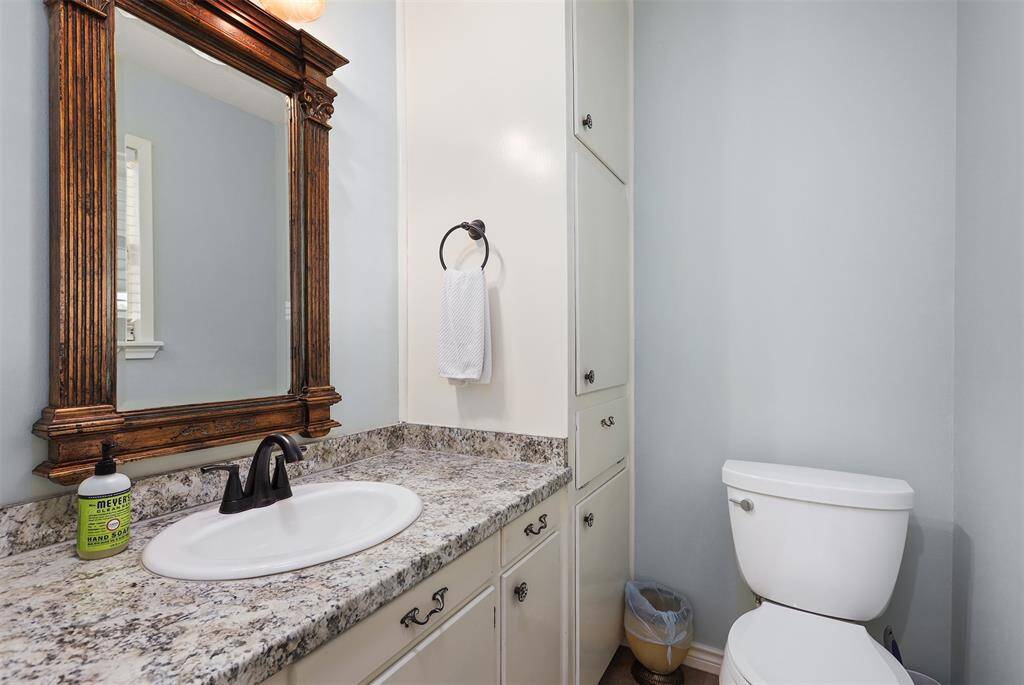 This half bath is conveniently located off the second bedroom, with easy access to the back porch.